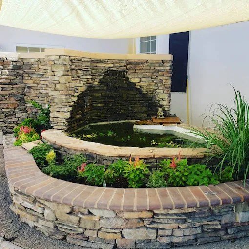 Stone water feature and flower beds in the courtyard